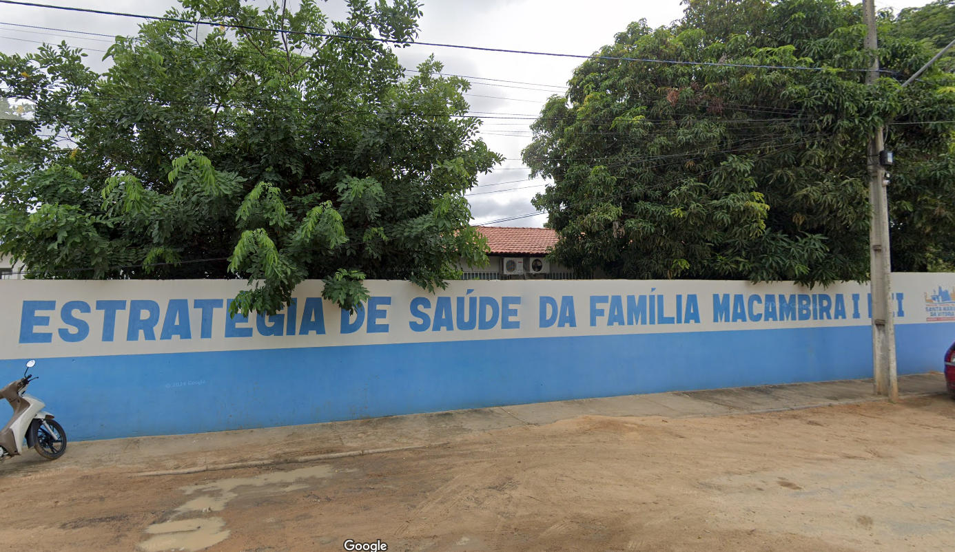 Entrada do posto de saúde Centro com placa e pessoas na fila